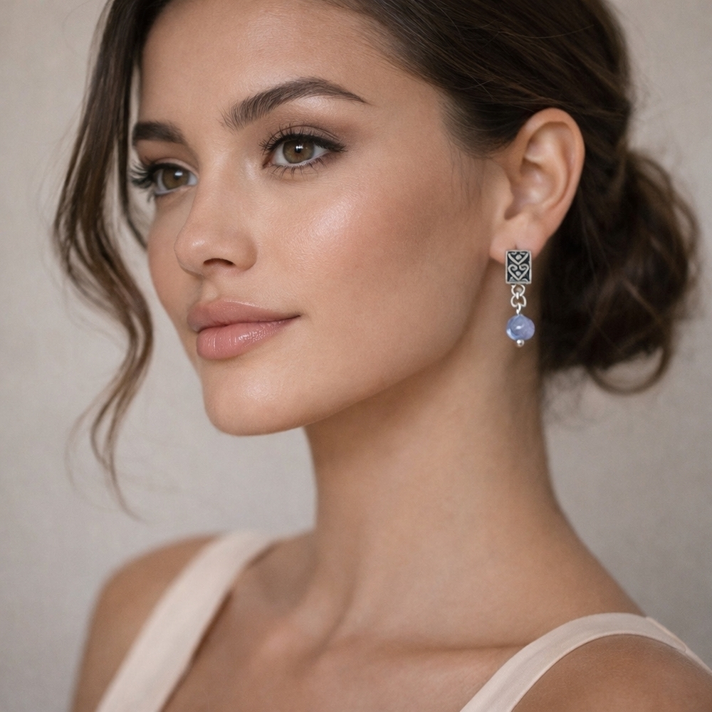 Silver distressed earrings with round blue gem